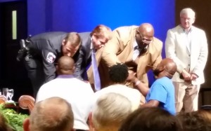 Police Chief Will Johnson, Mayor Jeff Williams and Pastor Dwight McKissic greet the family of Christian Taylor.